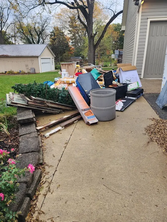 Dumpster being loaded with debris for Demolition Dumpster Rental in Raytown